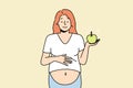 Smiling pregnant woman with apple