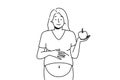 Smiling pregnant woman with apple