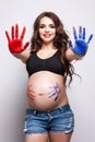 Smiling pregnant woman with bodyart