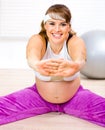 Smiling pregnant woman doing stretching exercises Royalty Free Stock Photo