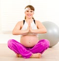 Smiling pregnant woman doing yoga exercises Royalty Free Stock Photo