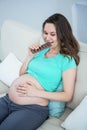 Smiling pregnant woman eating chocolate Royalty Free Stock Photo