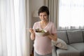 Smiling pregnant woman eating salad, fresh vegetables at home Royalty Free Stock Photo