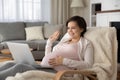 Smiling pregnant woman greet talking on video call Royalty Free Stock Photo