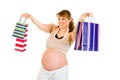 Smiling pregnant woman holding shopping bags Royalty Free Stock Photo