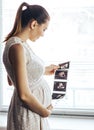 Pregnant girl with ultrasound result in hands Royalty Free Stock Photo