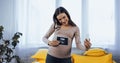 Smiling pregnant woman holding ultrasound scan Royalty Free Stock Photo