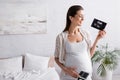 smiling and pregnant woman holding ultrasound Royalty Free Stock Photo