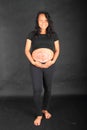 Smiling pregnant woman hugging drawing of baby on belly