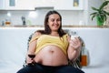 Smiling pregnant woman looking at milk Royalty Free Stock Photo