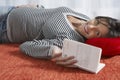 Smiling Pregnant Woman Lying On Floor With Book Royalty Free Stock Photo