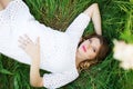 Smiling pregnant woman lying in grass Royalty Free Stock Photo