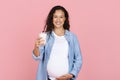 Smiling pregnant woman showing glass of diary Royalty Free Stock Photo