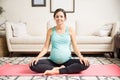 Smiling Pregnant Woman Sitting Crossed Legs On Fitness Mat
