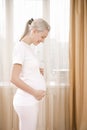 Smiling Pregnant Woman By Window