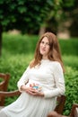 Pregnant woman holding a letter from plastic