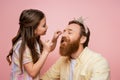 Smiling preteen girl applying eyeshadow on Royalty Free Stock Photo