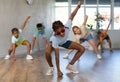 Preteenage boy and girl in sunglasses dancer practicing active dance in modern studio Royalty Free Stock Photo