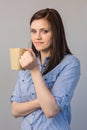 Smiling pretty brunette holding cup of coffee Royalty Free Stock Photo