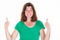 Smiling pretty brunette middle aged woman showing thumbs up