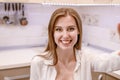 Smiling pretty caucasian woman taking a selfie while having breakfast.View from camera Royalty Free Stock Photo