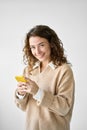 Smiling pretty curly young woman model using mobile phone. Royalty Free Stock Photo