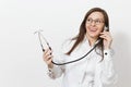 Smiling pretty fun experienced beautiful young doctor woman holding stethoscope isolated on white background. Female Royalty Free Stock Photo