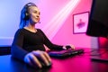 Happy and Beautiful Blonde Gamer Girl Playing Online Video Game on Her Personal Computer. Royalty Free Stock Photo