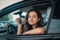 Happy Caucasian female car driver showing new car keys while sitting at driver seat. Lifestyle, transportation, sale Royalty Free Stock Photo