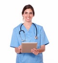 Smiling pretty lady nurse working on tablet pc Royalty Free Stock Photo