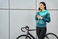 Happy woman with coffee standing near bike outdoors Royalty Free Stock Photo