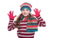 Smiling pretty little girl wearing colorful knitted scarf, hat and gloves isolated on white background. Winter clothes. Royalty Free Stock Photo