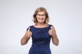 Smiling pretty mature woman showing thumbs up Royalty Free Stock Photo