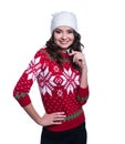 Smiling pretty young woman wearing colorful knitted sweater with christmas ornament and hat. Isolated on white background. Royalty Free Stock Photo