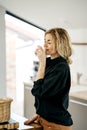 Smiling pretty woman drinking water from glass in the kitchen. Royalty Free Stock Photo