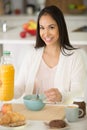 smiling pretty woman having breakfast in kitchen Royalty Free Stock Photo