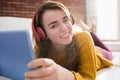 Smiling pretty woman listening music with her tablet Royalty Free Stock Photo