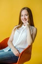Smiling pretty woman sitting on the chair Royalty Free Stock Photo