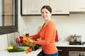 Smiling pretty woman washing fresh vegetables Royalty Free Stock Photo