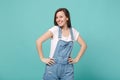 Smiling pretty young brunette woman girl in casual denim clothes posing isolated on blue turquoise wall background Royalty Free Stock Photo