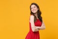 Smiling pretty young brunette woman girl in red summer dress posing isolated on yellow background studio portrait Royalty Free Stock Photo