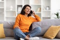 Smiling pretty young indian woman talking on phone at home Royalty Free Stock Photo