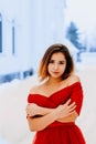 Smiling pretty young woman in beautiful shawl posing in a winter forest or park