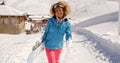 Smiling pretty young woman carrying a snowboard Royalty Free Stock Photo