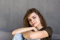 Smiling young woman wearing casual clothes relaxing on a couch at home Royalty Free Stock Photo