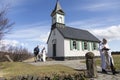 Smiling priest and couple with small child leaving Thingvallakirkja Church after very intimate wedding Royalty Free Stock Photo