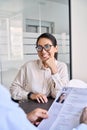 Smiling Asian woman candidate and hr manager holding cv during job interview. Royalty Free Stock Photo