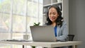 A smiling Asian senior businesswoman working on her business work on her laptop Royalty Free Stock Photo