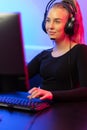 Smiling Professional E-sport Gamer Girl with Headset Playing Online Video Game Royalty Free Stock Photo