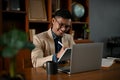 Smiling mature Asian businessman working on his business tasks on tablet Royalty Free Stock Photo